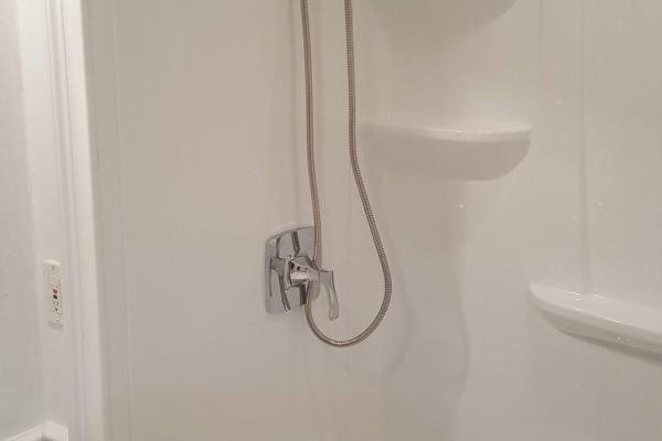 Overhead shower with a shower wand. 
