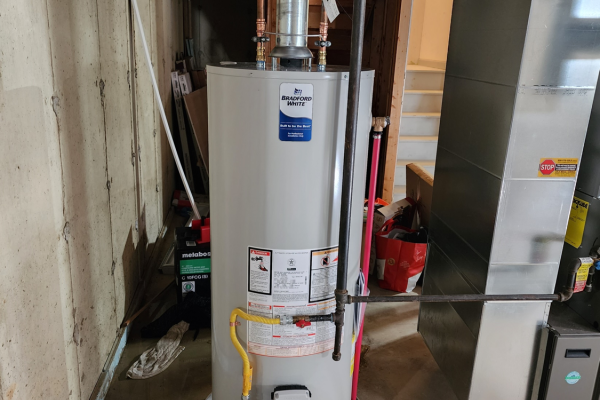 Efficient water heater replacement service by Applause Plumbing featuring a 50-gallon Bradford White unit with gas flex and chimney flue addition for optimal performance and safety. Expert plumbing solutions in action. The project was completed for a customer in Stewartsville, NJ.