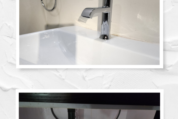 Newly installed modern bathroom faucet with a sleek design, professionally fitted by Applause Plumbing and Heating. Under-sink view of a double sink installation, showcasing new traplines and waste lines installed for efficient drainage.