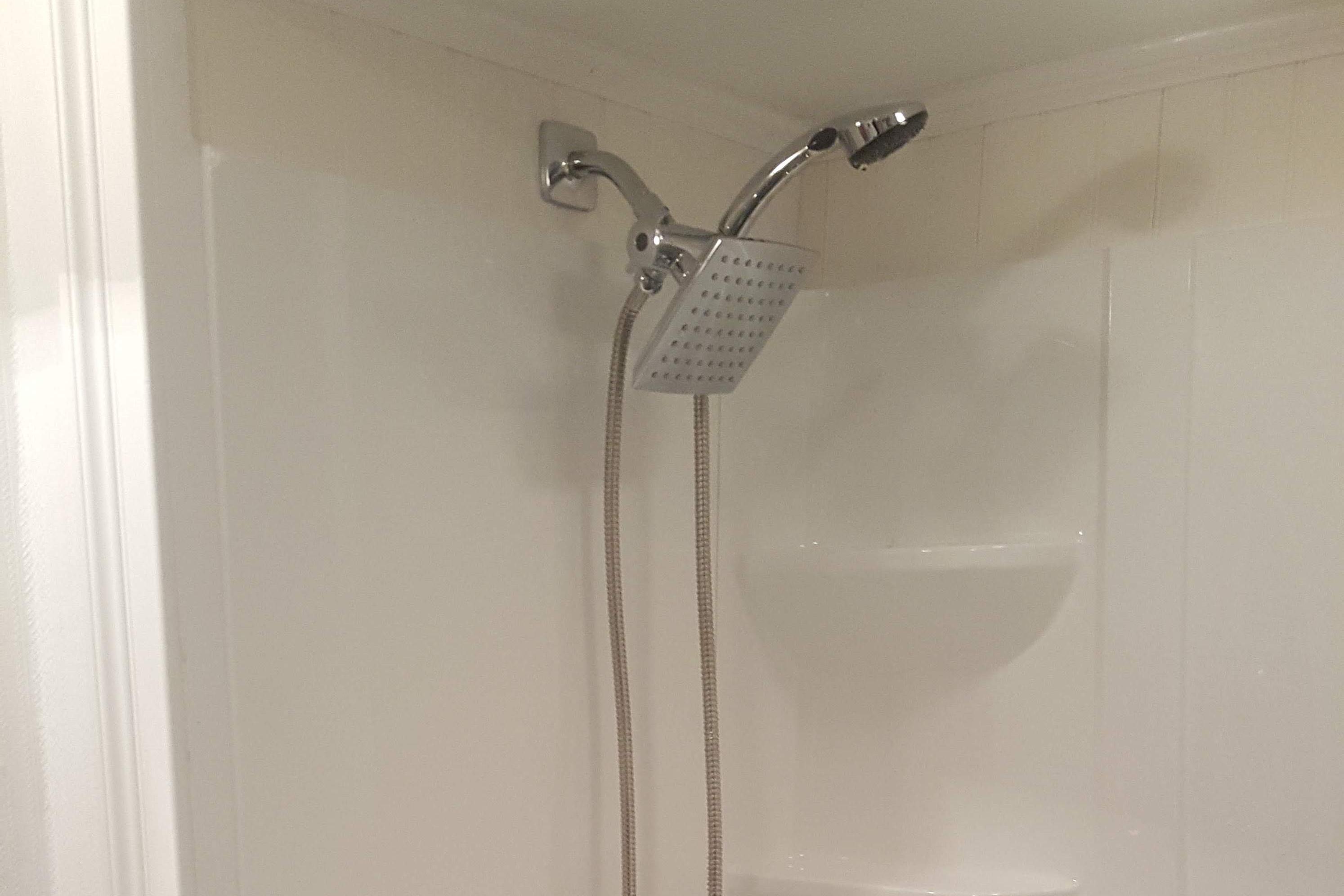 Overhead shower with a shower wand. 