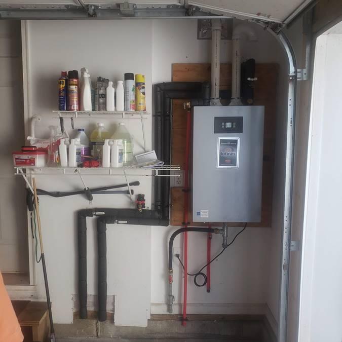 Tankless hot water heater in a garage. 