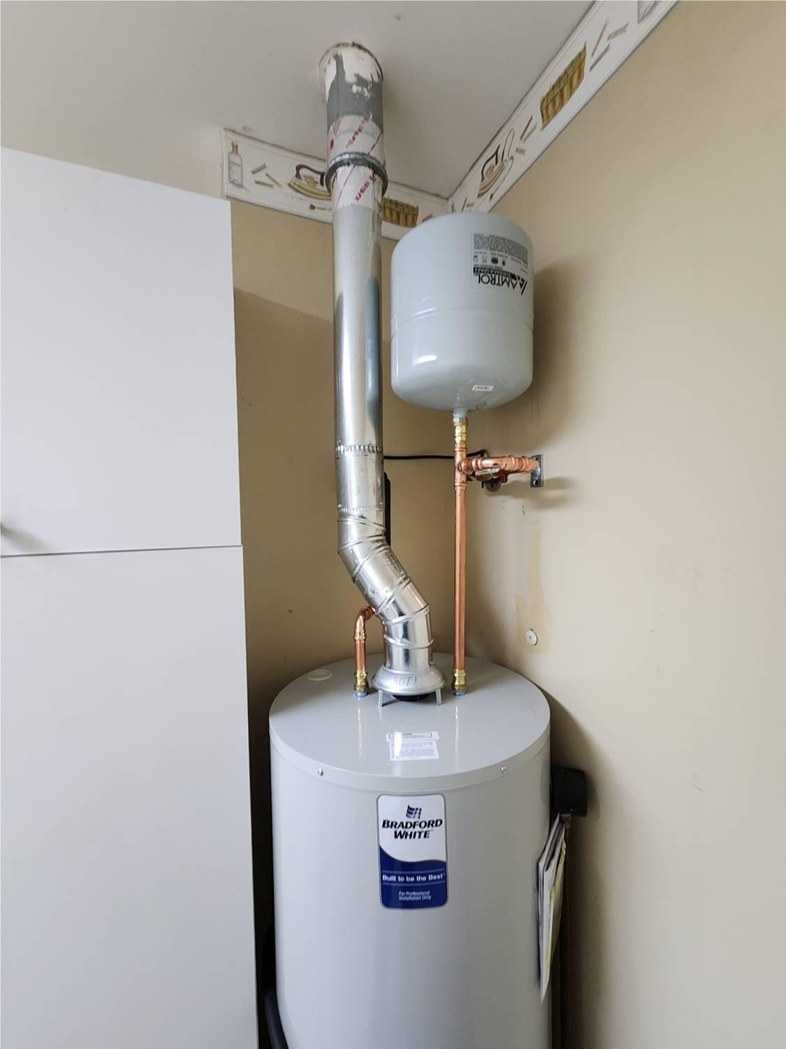 Bradford White hot water heater with a properly installed expansion tank to regulate water pressure and protect the plumbing system.